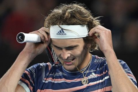 Germany's Alexander Zverev reacts after losing a point to Austria's Dominic Thiem during their semifinal match at the Australian Open tennis championship in Melbourne, Australia, Friday, Jan. 31, 2020. (AP Photo/Andy Brownbill)