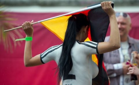 A porn actress with a body paint football jersey in the colors of Germany holds a German flag as she takes part in a fun soccer match of Germany vs Denmark on June 16, 2012 in Berlin, one day before the Euro 2012 football championship's match Germany vs Denmark to take place in Lviv, Ukraine. In the fun match, the girls of Denmark won 13-1.     AFP PHOTO / JOHANNES EISELE        (Photo credit should read JOHANNES EISELE/AFP/GettyImages)