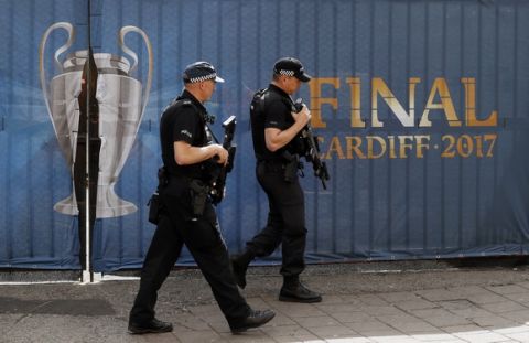 Armed police officers guard outside the Millennium Stadium in Cardiff, Wales, ahead of the Champions League final soccer match between Juventus and Real Madrid on Saturday June 3, 2017. (AP Photo/Kirsty Wigglesworth)