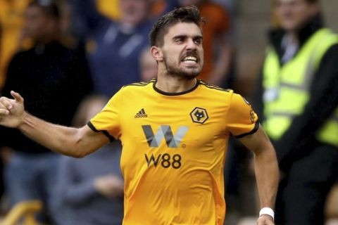 Wolverhampton Wanderers' Ruben Neves celebrates scoring his side's first goal of the game against Everton, during their English Premier League soccer match at Molineux in Wolverhampton, England, Saturday Aug. 11, 2018. (Nick Potts/PA via AP)