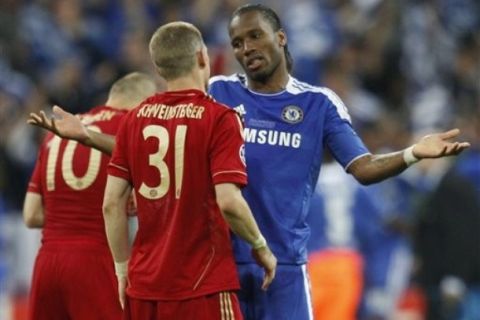 Chelsea's Didier Drogba, right, talks to Bayern's Bastian Schweinsteiger during the Champions League final soccer match between Bayern Munich and Chelsea in Munich, Germany Saturday May 19, 2012. (AP Photo/Matthias Schrader)