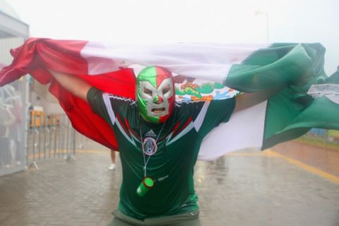 NATAL, BRAZIL - JUNE 13:  A Mexico fan braves the rain before the 2014 FIFA World Cup Brazil Group A match between Mexico and Cameroon at Estadio das Dunas on June 13, 2014 in Natal, Brazil.  (Photo by Miguel Tovar/Getty Images)