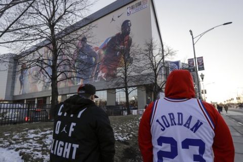 Fans make their way to the United Center for the NBA All-Star basketball game Sunday, Feb. 16, 2020, in Chicago. (AP Photo/Nam Huh)