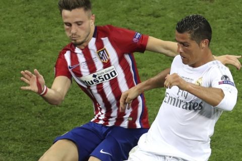FILE - In this May 28, 2016, file photo, Real Madrid's Cristiano Ronaldo fights for the ball against Atletico's Saul Niguez during the Champions League final soccer match in Milan, Italy. Madrid arrives at the derby in a much better position than previously, holding a two-point lead over Barcelona and a six-point advantage over Diego Simeone's Atletico, which needs the victory to avoid losing more ground to the rivals. (AP Photo/Alessandra Tarantino, File)