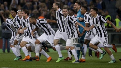 Juventus players celebrate their 4-0 win at the end of the Italian Cup final soccer match between Juventus and AC Milan, at the Rome Olympic stadium, Wednesday, May 9, 2018. (AP Photo/Gregorio Borgia)