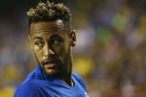 Brazil forward Neymar speaks with a teammate in the first half of a soccer match against El Salvador, Tuesday, Sept. 11, 2018, in Landover, Md. (AP Photo/Patrick Semansky)