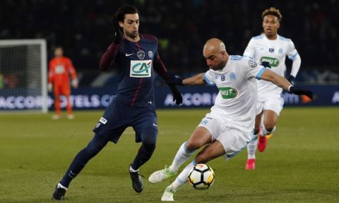 PSG's Javier Pastore, left, challenges for the ball with Marseille's Aymen Abdennour during the French Cup soccer match between Paris Saint-Germain and Marseille at the Parc des Princes Stadium, in Paris, France, Wednesday, Feb. 28, 2018. (AP Photo/Thibault Camus)