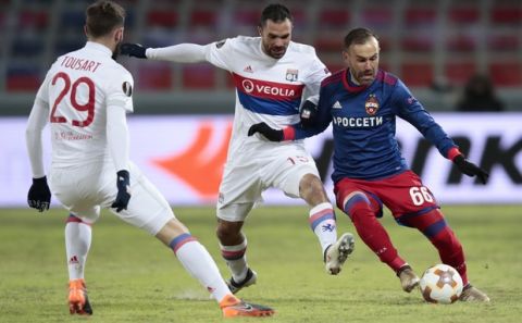 CSKA's Bibras Natcho, right, Lyon's Jeremy Morel, centre, Lyon's Lucas Tousart battle for the ball during the Europa League, round of 16 first leg soccer match between CSKA Moscow and Lyon, in Moscow, Russia, Thursday, March 8, 2018. (AP Photo/Denis Tyrin)