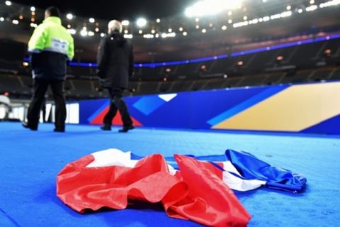 epa05023967 A French national flag lays on the ground in the stadium after the international friendly soccer match between France and Germany at Stade de Fance in Paris, France, 13 November 2015. Dozens of people have been killed in a series of attacks, which included explosions outside the stadium, in Paris on 13 November.  EPA/UWE ANSPACH
