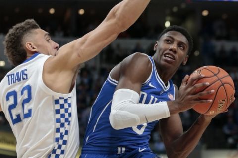 Duke forward RJ Barrett (5) shoots around Kentucky forward Reid Travis (22) during the first half of an NCAA college basketball game at the Champions Classic in Indianapolis on Tuesday, Nov. 6, 2018. (AP Photo/AJ Mast)
