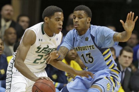 Marquette guard Vander Blue (13) blocks South Florida guard Javontae Hawkins (23) during the first half of an NCAA college basketball game Wednesday, Feb. 6, 2013, in Tampa, Fla. (AP Photo/Chris O'Meara) 