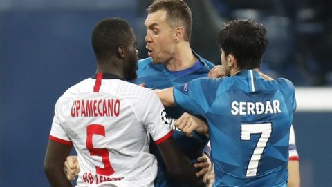 Zenit's Artem Dzyuba, centre, scuffles with Leipzig's Dayot Upamecano, left, during the Champions League group G soccer match between Zenit St. Petersburg and RB Leipzig at the Saint Petersburg stadium in St.Petersburg, Russia, Tuesday, Nov. 5, 2019. (AP Photo/Dmitri Lovetsky)