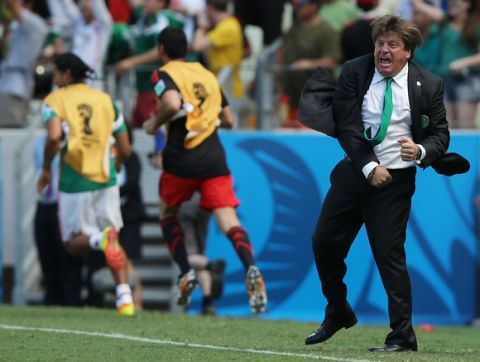 FORTALEZA, BRAZIL - JUNE 29:  Head coach Miguel Herrera of Mexico celebrates his team's first goal during the 2014 FIFA World Cup Brazil Round of 16 match between Netherlands and Mexico at Castelao on June 29, 2014 in Fortaleza, Brazil.  (Photo by Dean Mouhtaropoulos/Getty Images)