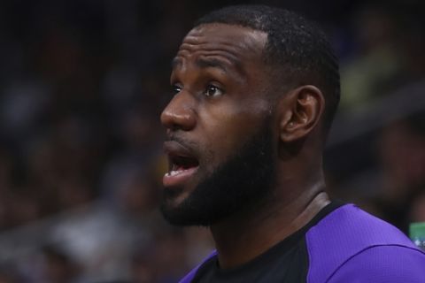 Los Angeles Lakers' LeBron James reacts to a play during the first half of the team's preseason NBA basketball game against the Golden State Warriors on Friday, Oct. 12, 2018, in San Jose, Calif. (AP Photo/Ben Margot)