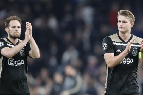 Ajax's Daley Blind and captain Matthijs de Ligt, right, celebrate their team's 1-0 win after the Champions League semifinal first leg soccer match between Tottenham Hotspur and Ajax at the Tottenham Hotspur stadium in London, Tuesday, April 30, 2019. (AP Photo/Frank Augstein)