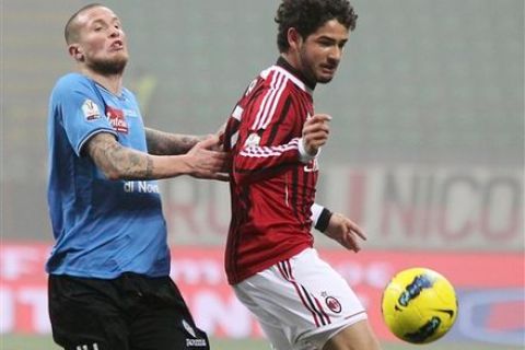 AC Milan Brazilian forward Pato, right, challenges for the ball with Novara defender Michel Morganella, of Switzerland, during the Italian Cup eight final soccer match between AC Milan and Novara, at the San Siro stadium in Milan, Italy, Wednesday, Jan. 18, 2012. (AP Photo/Antonio Calanni)