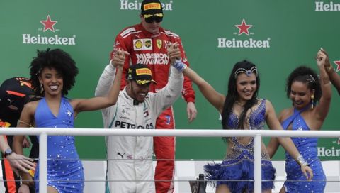 Mercedes driver Lewis Hamilton, of Britain, celebrates the podium after winning the Brazilian Formula One Grand Prix at the Interlagos race track in Sao Paulo, Brazil, Sunday, Nov. 11, 2018. (AP Photo/Andre Penner)