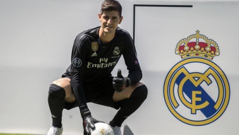 Belgian new Real Madrid soccer player Thibaut Courtois poses for the media during his official presentation for Real Madrid at the Santiago Bernabeu stadium in Madrid, Thursday, Aug. 9, 2018. Chelsea has sold a player  goalkeeper Thibaut Courtois  to Real Madrid. The Belgian was replaced by Kepa Arrizabalaga after Chelsea met the goalkeeper's 80 million euro ($93 million) buyout clause from Athletic Bilbao on Wednesday. (AP Photo/Andrea Comas)