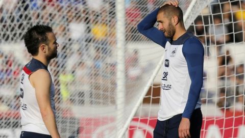 FILE - In this June 10, 2014, file photo, France's Mathieu Valbuena, left, and Karim Benzema, right, chat during a training session of the french national soccer team, at the Santa Cruz Stadium in Ribeirao Preto, Brazil. Benzema has been arrested Wednesday Nov.4, 2015 as part of an investigation into a blackmail case involving another football player. Police are trying to find out which role the Real Madrid forward played in the extortion attempt targeting France midfielder   Valbuena, and if he actually tried to blackmail the Lyon player over a sex tape. (AP Photo/David Vincent, File)