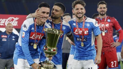 Napoli's Jose Callejon, left, holds the Italian Cup trophy with his teammates Lorenzo Insigne, center, and Dries Mertens at the end of the final match between Napoli and Juventus, at Rome's Olympic Stadium, Wednesday, June 17, 2020. (AP Photo/Andrew Medichini7