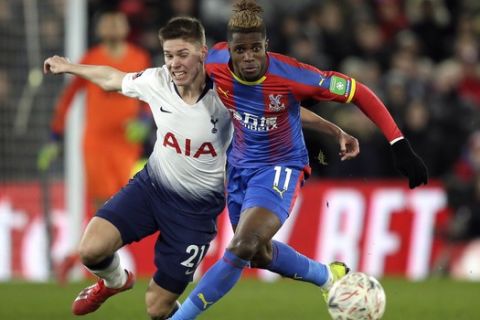 Tottenham's Juan Foyth fights for the ball with Crystal Palace's Wilfried Zaha, right, during an English FA Cup fourth round soccer match between Crystal Palace and Tottenham Hotspur at Selhurst Park in London, Sunday, Jan. 27, 2019. (AP Photo/Tim Ireland)