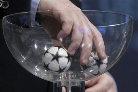 A hand removes the balls containing the names of the soccer clubs, during the drawing of the games for the Champions League 2010/11 qualifying round, at the UEFA headquarters in Nyon, Switzerland, Monday, June 21, 2010. (AP Photo/Keystone/Salvatore Di Nolfi)