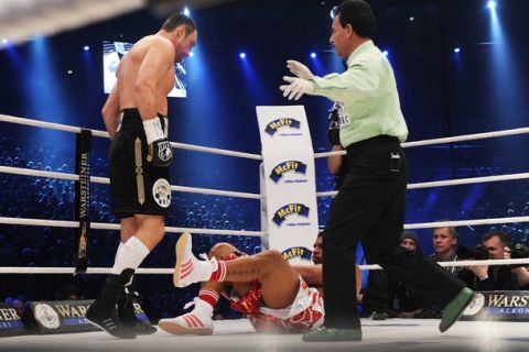 Ukrainian heavyweight titleholder Vitali Klitschko (L) stands over Cuban challenger Odlanier Solis who fell as the referee gestures during their WBC heavyweight world championship boxing match in the western German city of Cologne on March 19, 2011. World heavyweight champion Vitali Klitschko won the fight and defended his WBC heavyweight title with a shock first-round knock-out of Cuban challenger Odlanier Solis.  AFP PHOTO / PATRIK STOLLARZ (Photo credit should read PATRIK STOLLARZ/AFP/Getty Images)