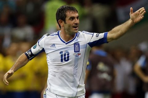 Greece's Giorgos Karagounis celebrates after scoring during the Euro 2012 soccer championship Group A  match between Greece and Russia in Warsaw, Poland, Saturday, June 16, 2012. (AP Photo/Matt Dunham)