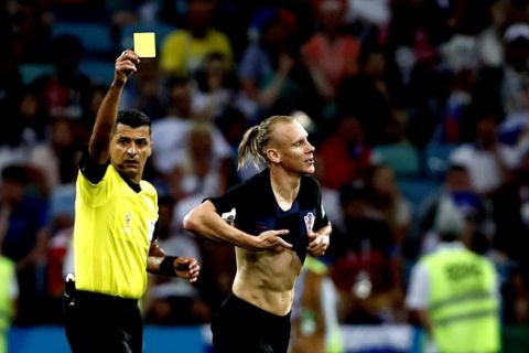 Referee Sandro Ricci from Brazil shows a yellow card to Croatia's Domagoj Vida during the quarterfinal match between Russia and Croatia at the 2018 soccer World Cup in the Fisht Stadium, in Sochi, Russia, Saturday, July 7, 2018. (AP Photo/Rebecca Blackwell)
