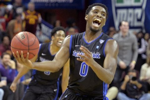 Buffalo's Blake Hamilton, front, and CJ Massinburg celebrate a win over Akron in an NCAA college basketball game in the championship of the Mid-American Conference men's tournament, Saturday, March 12, 2016, in Cleveland. (AP Photo/David Richard)