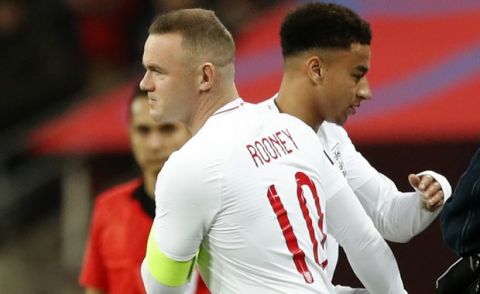 England's Wayne Rooney substitutes England's Dele Ali, right, for his 120th cap during the international friendly soccer match between England and the United States at Wembley stadium, Thursday, Nov. 15, 2018. (AP Photo/Alastair Grant)