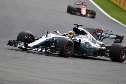 Mercedes driver Lewis Hamilton of Britain, foreground, steers his car during the qualifying session ahead of the Belgian Formula One Grand Prix in Spa-Francorchamps, Belgium, Saturday, Aug. 26, 2017. Lewis Hamilton has secured pole position for the Belgian Grand Prix, equalling Michael Schumacher's record of 68 career poles. (AP Photo/Geert Vanden Wijngaert)
