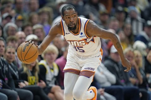 Phoenix Suns forward Kevin Durant (35) brings the ball up court during the first half of an NBA basketball game, Sunday, Nov. 19, 2023, in Salt Lake City. (AP Photo/Rick Bowmer)