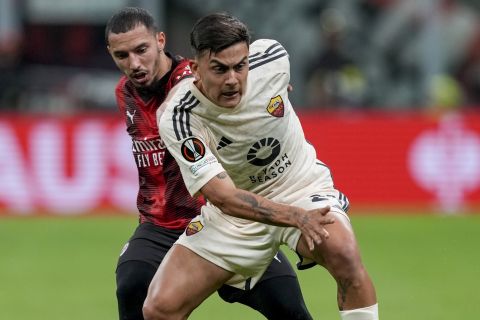 AC Milan's Ismael Bennacer, left, and Roma's Paulo Dybala fight for the ball during the Europa League quarterfinal first leg soccer match between AC Milan and Roma at the San Siro Stadium, in Milan, Italy, Thursday, April 11, 2024. (AP Photo/Antonio Calanni)