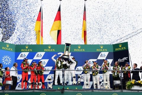LE MANS, FRANCE - JUNE 14:  Porche Team Nico Hulkenberg, Earl Bamber and Nick Tandy celebrate winning the Le Mans 24 Hour race at the Circuit de la Sarthe on June 14, 2015 in Le Mans, France.  (Photo by Shaun Botterill/Getty Images)