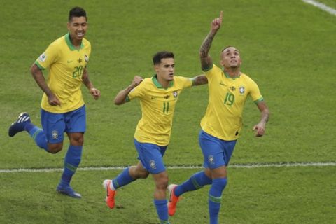 Brazil's Everton (19) celebrates scoring his side's opening goal against Peru with teammates Phlippe Coutinho (11) and Roberto Firmino during the final soccer match of the Copa America at the Maracana stadium in Rio de Janeiro, Brazil, Sunday, July 7, 2019. (AP Photo/Natacha Pisarenko)