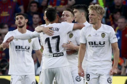 Valencia forward Kevin Gameiro, third right, celebrates with teammates after scoring a goal during the Copa del Rey soccer match final between Valencia CF and FC Barcelona at the Benito Villamarin stadium in Seville, Spain, Saturday. 25, 2019. (AP Photo/Miguel Morenatti)