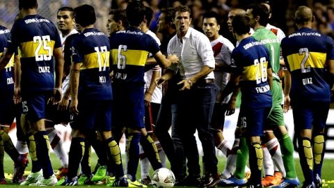 Boca Juniors'coach Rodolfo Arruabarrena, center in white shirt, helps breaks a scuffle between his players and River Plate's during the first leg of the Copa Sudamericana sem-ifinal soccer match in Buenos Aires, Argentina,  Thursday, Nov. 20, 2014. (AP Photo/Victor R. Caivano)