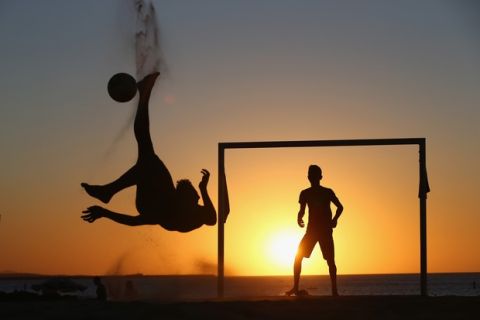 FORTALEZA, BRAZIL - JUNE 22:  Locals play football at the Iracemar beach on June 22, 2014 in Fortaleza, Brazil.  (Photo by Michael Steele/Getty Images)