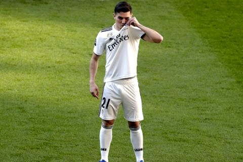 Newly signed Real Madrid soccer player Brahim Diaz kisses his new shirt during his official presentation at the Bernabeu stadium in Madrid, Spain, Monday, Jan. 7, 2019. Real Madrid has signed Brahim Diaz from Manchester City after the 19-year-old winger failed to get enough first-team opportunities at the Premier League champions. Madrid announced the arrival of Diaz on Sunday, saying he signed a contract until 2025. (AP Photo/Manu Fernandez)