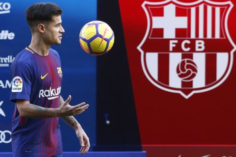 Barcelona's new signing Brazilian Philippe Coutinho poses for the media, during his official presentation at the Camp Nou stadium in Barcelona, Spain, Monday, Jan. 8, 2018. Coutinho is joining Barcelona after Liverpool agreed Saturday to sell the Brazilian in a deal that makes him one of the most expensive players in soccer history. (AP Photo/Manu Fernandez)