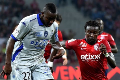 Lille's Senegalese defender Pape Souare (R) vies with Bastia's French midfielder Christopher Maboulou during the French L1 football match Lille vs Bastia on September 27, 2014 at the " Pierre Mauroy " stadium in Villeneuve-d'Ascq,  northern France. AFP PHOTO PHILIPPE HUGUEN        (Photo credit should read PHILIPPE HUGUEN/AFP/Getty Images)