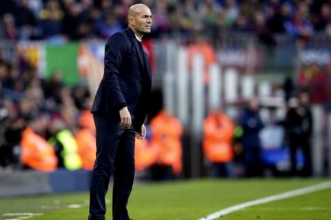 Real Madrid's head coach Zinedine Zidane looks from the sidelines during the Spanish La Liga soccer match between FC Barcelona and Real Madrid at the Camp Nou in Barcelona, Spain, Saturday, Dec. 3, 2016. (AP Photo/Manu Fernandez)