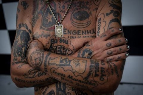 TO GO WITH AFP STORY by Javier Tovar
Brazilian football club Botafogo fan Delneri Martins Viana, a 69-year-old retired soldier, shows his tattoos at his home in Rio de Janeiro, Brazil, on January 18, 2014. Delneri has 83 tattoos on his body dedicated to Botafogo and describes himself as the club's biggest fan.   AFP PHOTO / YASUYOSHI CHIBA