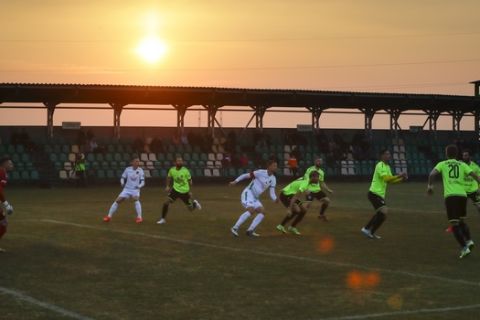 In this photo taken on Saturday, March 28, 2020, players in action at sunset during the Belarus Championship soccer match between Gorodeya and Shakhter in the town of Gorodeya, Belarus. Longtime Belarus President Alexander Lukashenko is proudly keeping soccer and hockey arenas open even though most sports around the world have shut down because of the coronavirus pandemic. The new coronavirus causes mild or moderate symptoms for most people, but for some, especially older adults and people with existing health problems, it can cause more severe illness or death. (AP Photo/Sergei Grits)