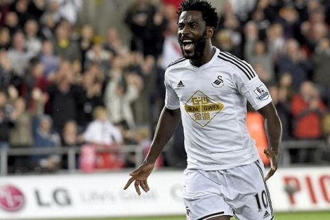 Swansea City's Wilfried Bony celebrates scoring his second goal against Leicester City during their English Premier League soccer match at the Liberty Stadium in Swansea, Wales, October 25, 2014. REUTERS/Rebecca Naden (BRITAIN - Tags: SPORT SOCCER) NO USE WITH UNAUTHORIZED AUDIO, VIDEO, DATA, FIXTURE LISTS, CLUB/LEAGUE LOGOS OR "LIVE" SERVICES. ONLINE IN-MATCH USE LIMITED TO 45 IMAGES, NO VIDEO EMULATION. NO USE IN BETTING, GAMES OR SINGLE CLUB/LEAGUE/PLAYER PUBLICATIONS. FOR EDITORIAL USE ONLY. NOT FOR SALE FOR MARKETING OR ADVERTISING CAMPAIGNS