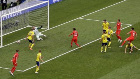 England's Harry Maguire, right, scores the opening goal during the quarterfinal match between Sweden and England at the 2018 soccer World Cup in the Samara Arena, in Samara, Russia, Saturday, July 7, 2018. (AP Photo/Thanassis Stavrakis)