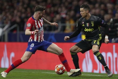 Atletico midfielder Saul Niguez, left, tries to stop Juventus forward Cristiano Ronaldo during the Champions League round of 16 first leg soccer match between Atletico Madrid and Juventus at Wanda Metropolitano stadium in Madrid, Wednesday, Feb. 20, 2019. (AP Photo/Manu Fernandez)