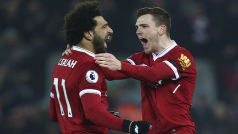 Liverpool's Andrew Robertson, right, celebrates with Mohamed Salah after Salah scored his side's fourth goal during the English Premier League soccer match between Liverpool and Manchester City at Anfield Stadium, in Liverpool, England, Sunday Jan. 14, 2018. (AP Photo/Dave Thompson)