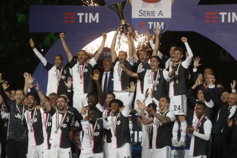 Juventus players celebrate after winning the Serie A soccer title trophy, at the Allianz Stadium, in Turin, Italy, Sunday, May 19, 2019. (AP Photo/Antonio Calanni)